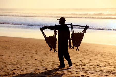 Bali , Indonesia - 22 February, 2012: Speanut seller on the beach at sunset. Bali , Indonesiaのeditorial素材