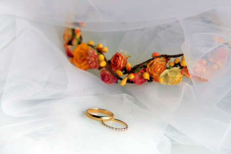 Wedding rings on a blue satiny fabricの写真素材