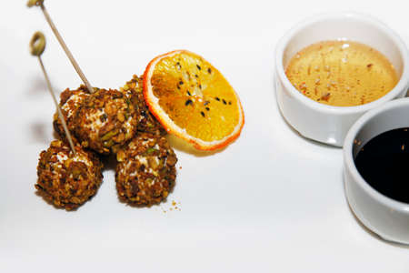 Cheese balls on skewers with saucesの写真素材