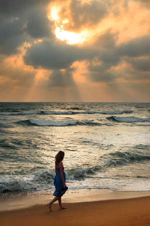 Girl on a beach on sunset in Sri Lankaの写真素材