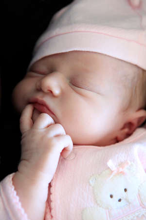 Sleeping newborn baby. The first days of life of the newborn girlの写真素材