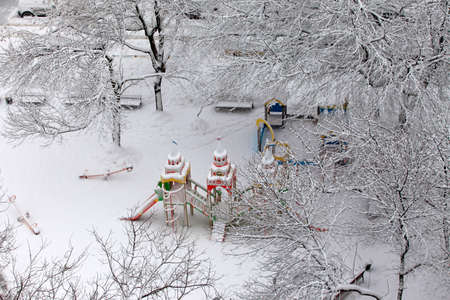 Deserted children's playground covered with snowの写真素材