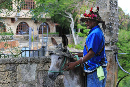 Dominican Republic, La Romana - January 08, 2018: Man and his donkey in Altos de Chavon, Dominican Republic. La Romanaのeditorial素材