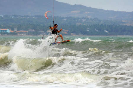 Kiteboarder enjoy surfing in ocean. Vietnamの写真素材