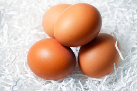 Four brown eggs fresh in paper