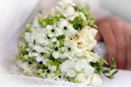 Hand of the bride with wedding bouquetの写真素材