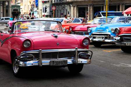 Havana, Cuba - January 10, 2019: Vintage cars moving on the streets of colorful Havana. A great variety of old cars exist In Cuba. On the streets cars from the first half of the 20th century can be found in magnificent conditions, which takes back in histのeditorial素材