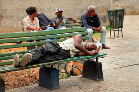 Havana, Cuba - January 10, 2019: Homeless man lying on a bench in old Havana, Cubaのeditorial素材