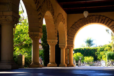 Long corridor at Stanford California. Amber sculpted stones columnsのeditorial素材