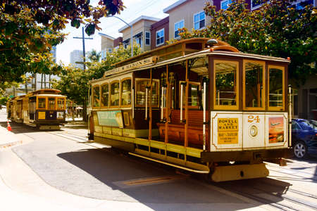 SAN FRANCISCO, CA, USA - AUGUST 17, 2013: Passengers ride in a cable car on August 17, 2013 in San Francisco. It is the most popular way to get around the City of San Fransisco which is in service since 1873.のeditorial素材