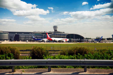 Miami, Florida, USA - May 9, 2013: Panoramic photo of the famous Miami International Airport with lots of airplanes loading and unloading passenger and cargo on May 9, 2013 in Miami, Florida, USA.のeditorial素材