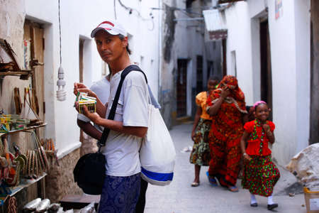 Stone Town, Tanzania - January 10, 2016: A tourist buys souvenirs on Stone Town in Tanzaniaのeditorial素材