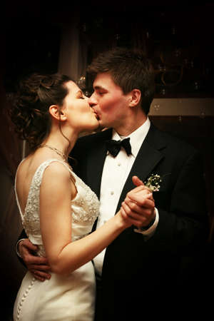 Romantic moment between bride and groom kissing celebrating their wedding dayの写真素材