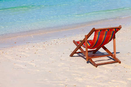 Wooden beach chair on a beautiful ocean shoreの写真素材