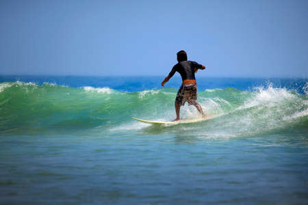 Surfer on a coastline expecting the big wave. Baliの写真素材