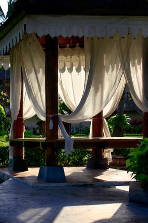 Arbor with white curtains for relaxation or meditation. Bali Island, Indonesia.の写真素材