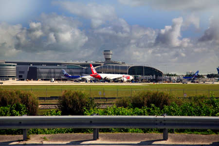 Miami, Florida, USA - May 9, 2013: Panoramic photo of the famous Miami International Airport with lots of airplanes loading and unloading passenger and cargo on May 9, 2013 in Miami, Florida, USA.のeditorial素材