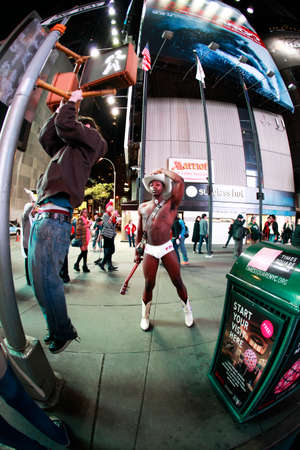 Naked Cowboy showing muscles on Times Square, New Yorkのeditorial素材