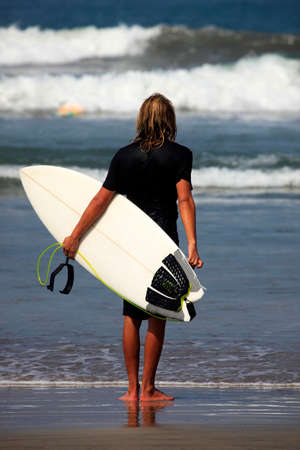 Lonely the man-surfer on a coastline. Baliの写真素材