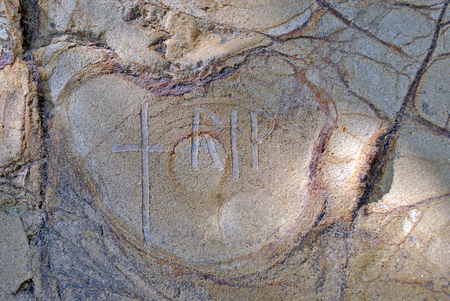 rest in peace cross on cliff sideの写真素材