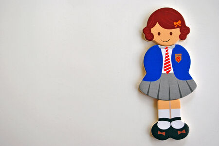 wooden toy figurine girl wearing school uniformの写真素材