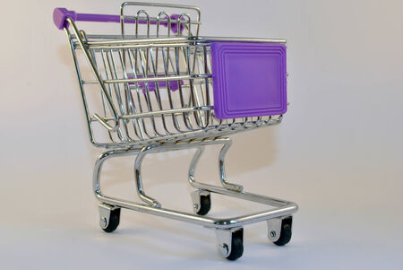 one single isolated empty purple shopping trolleyの写真素材