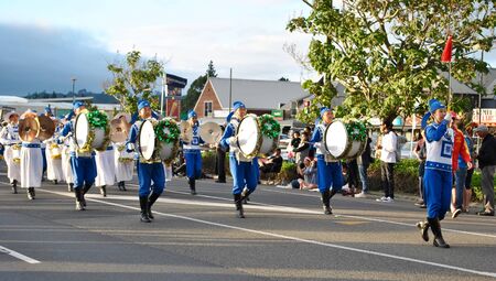 Hari Krishna band marching through the street in kumeu new zealand during a christmas street paradeのeditorial素材