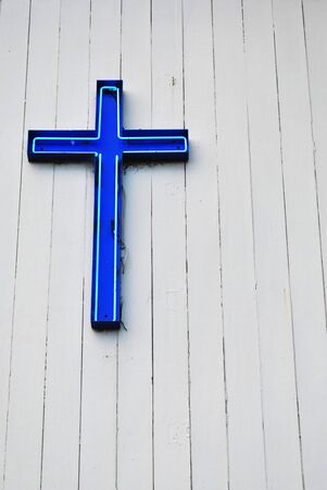 blue christian cross on white church wallの写真素材