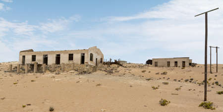 NAMIBIA, KOLMANSKOP - SEPTEMBER, 14. 2014: Ghost Town Kolmanskop, former Diamond Dagger Town in desert stripe near Luederitz. It was used from 1908 till 1930. Now it's abandoned and desertificated.のeditorial素材