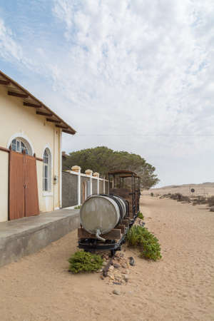 NAMIBIA, KOLMANSKOP - SEPTEMBER, 14. 2014: Ghost Town Kolmanskop, former Diamond Dagger Town in desert stripe near Luederitz. It was used from 1908 till 1930. Now it's abandoned and desertificated. Train.のeditorial素材