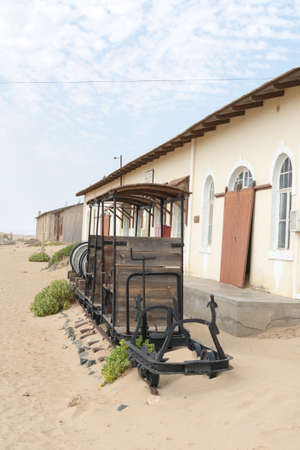 NAMIBIA, KOLMANSKOP - SEPTEMBER, 14. 2014: Ghost Town Kolmanskop, former Diamond Dagger Town in desert stripe near Luederitz. It was used from 1908 till 1930. Now it's abandoned and desertificated. Train.のeditorial素材