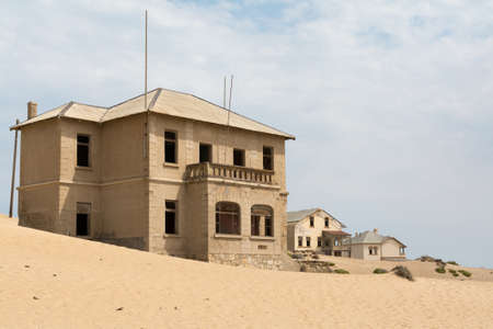 NAMIBIA, KOLMANSKOP - SEPTEMBER, 14. 2014: Ghost Town Kolmanskop, former Diamond Dagger Town in desert stripe near Luederitz. It was used from 1908 till 1930. Now it's abandoned and desertificated. Architect Building.のeditorial素材