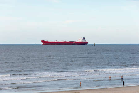 WANGEROOGE, GERMANY.  05th July 2017:  View of a cargo ship passing the isle wangerooge, one of the seven german east frisian ilands, is a beautiful wadden sea island located in the german sea.のeditorial素材