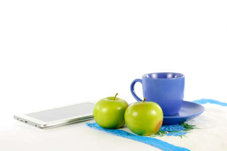 Apples with a cup of tea on a white backgroundの写真素材