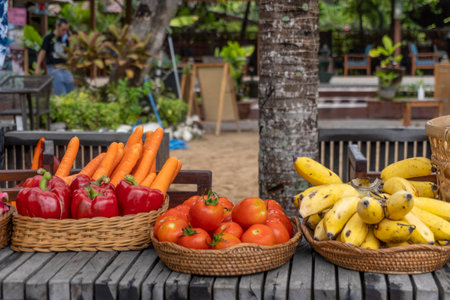 Fruits and vegetables in baskets on wooden table in the garden.の写真素材