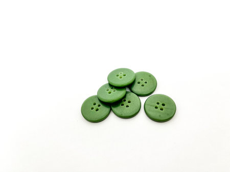Green buttons isolated on white background. Shallow depth of field.の写真素材