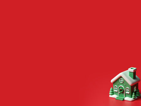 Miniature Christmas house on red background with copy space for your text.の写真素材