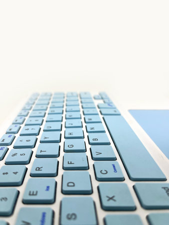 Close up of a laptop keyboard on white background with copy space.