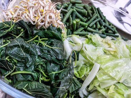 Fresh vegetables in a plastic container for sale at a market stall.の写真素材