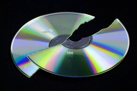 data loss -- broken CD or DVD isolated on black ground