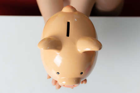 Piggy bank on white tableの写真素材