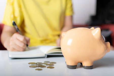 Piggy bank on white tableの写真素材