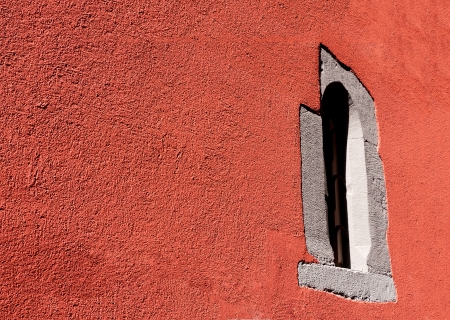 window in the red front of a houseの写真素材