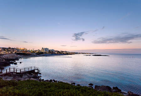 Photo of sea in protaras, cyprus island, with rocks and hotels at sunset.の写真素材