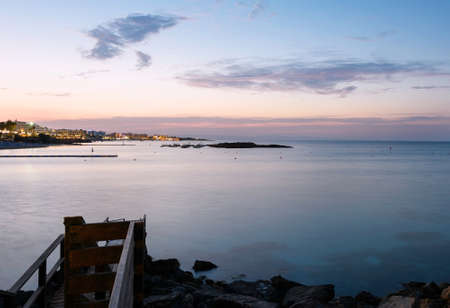 Photo of sea in protaras, cyprus island, with rocks and hotels at sunset.の写真素材