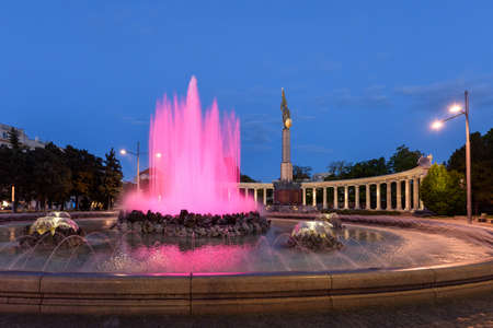 The heroes monument of the red army in schwarzenbergplatz at night with pink light fountain in vienna, austriaの写真素材