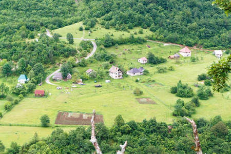 Village on mountains and fog near Budva old city in Montenegroの写真素材