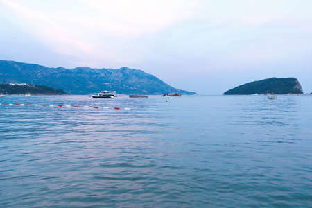 Budva the old town cloudy sky over ships and clean sea at sunset, mountain island, montenegro, europeの写真素材
