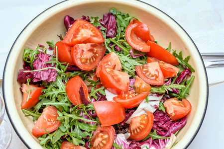 Close up photo of green healthy salad with ruccola and tomatoesの写真素材