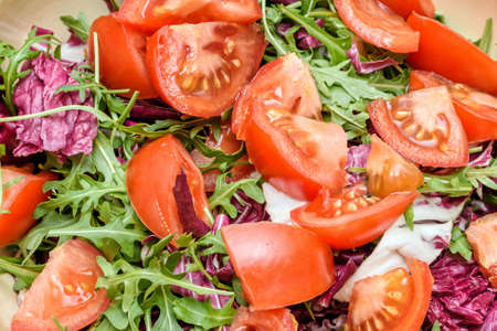 Close up photo of green healthy salad with ruccola and tomatoesの写真素材